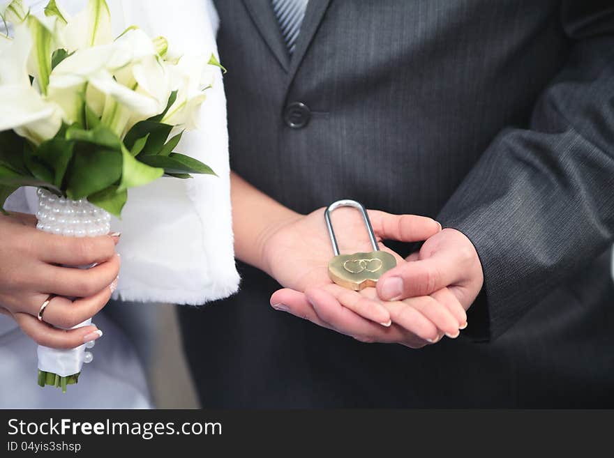 The lock in hands of newlyweds,new family