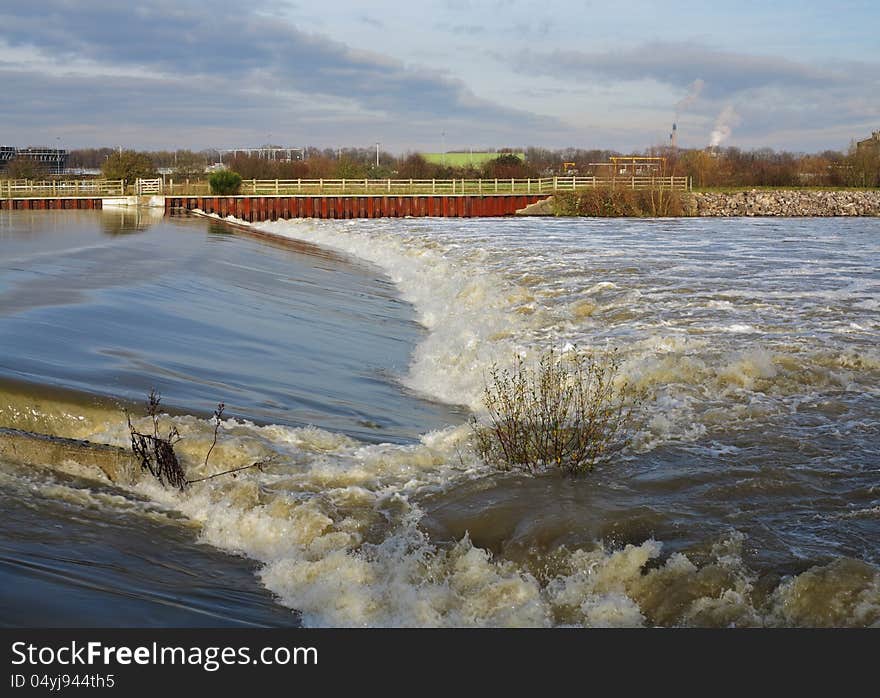 Flood water passing over a Weir and Barrier on the Jubilee Flood relief River in England