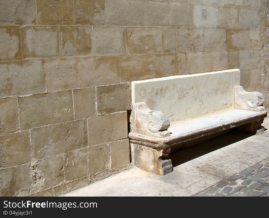 Old stone bench in historic part of town Mahon, Menorca, Spain