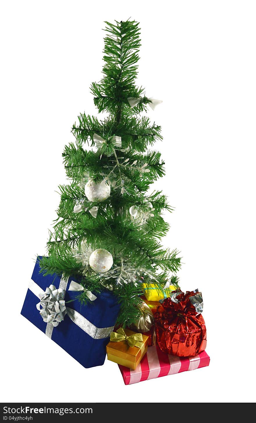 The artificial green conifer with heap of colorful gifts. The artificial green conifer with heap of colorful gifts