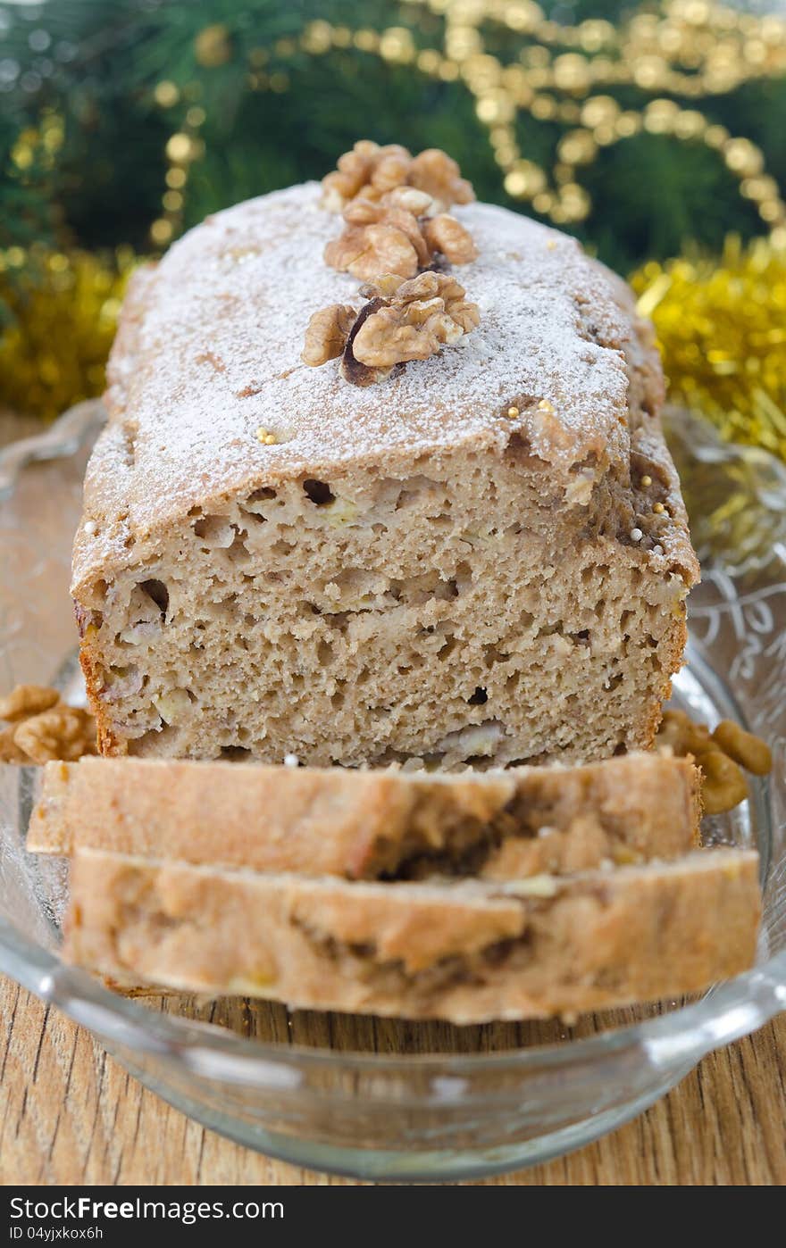 Christmas Banana cake with walnut dusted with icing sugar closeup