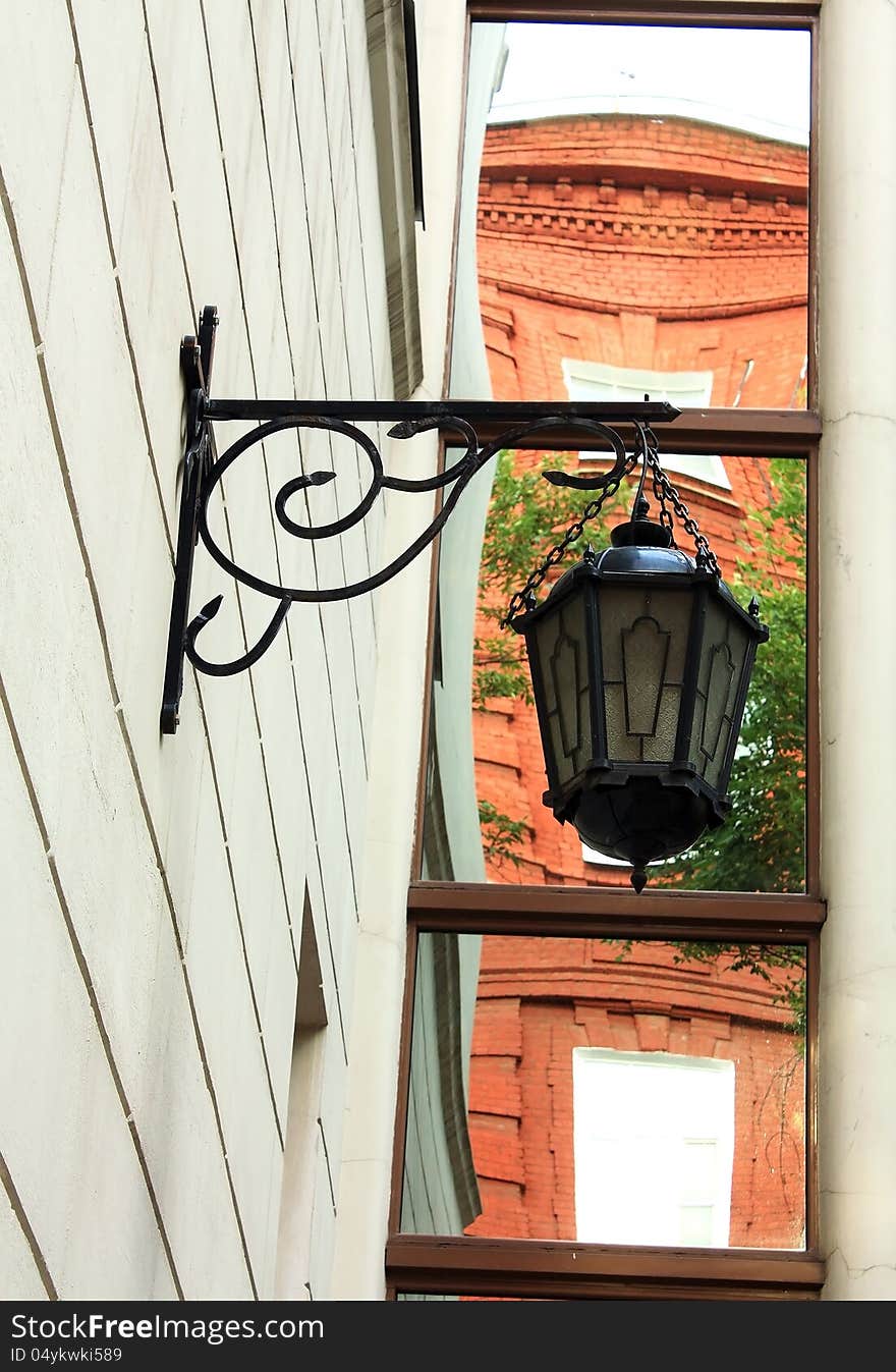 Black vintage lamp decorating the entrance of the building. Black vintage lamp decorating the entrance of the building