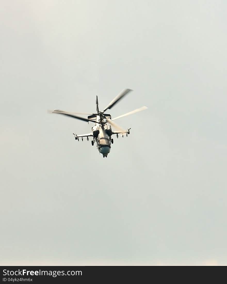 Perform aerobatics by the modern russian attack helicopter Ka-50 at the airshow. Perform aerobatics by the modern russian attack helicopter Ka-50 at the airshow