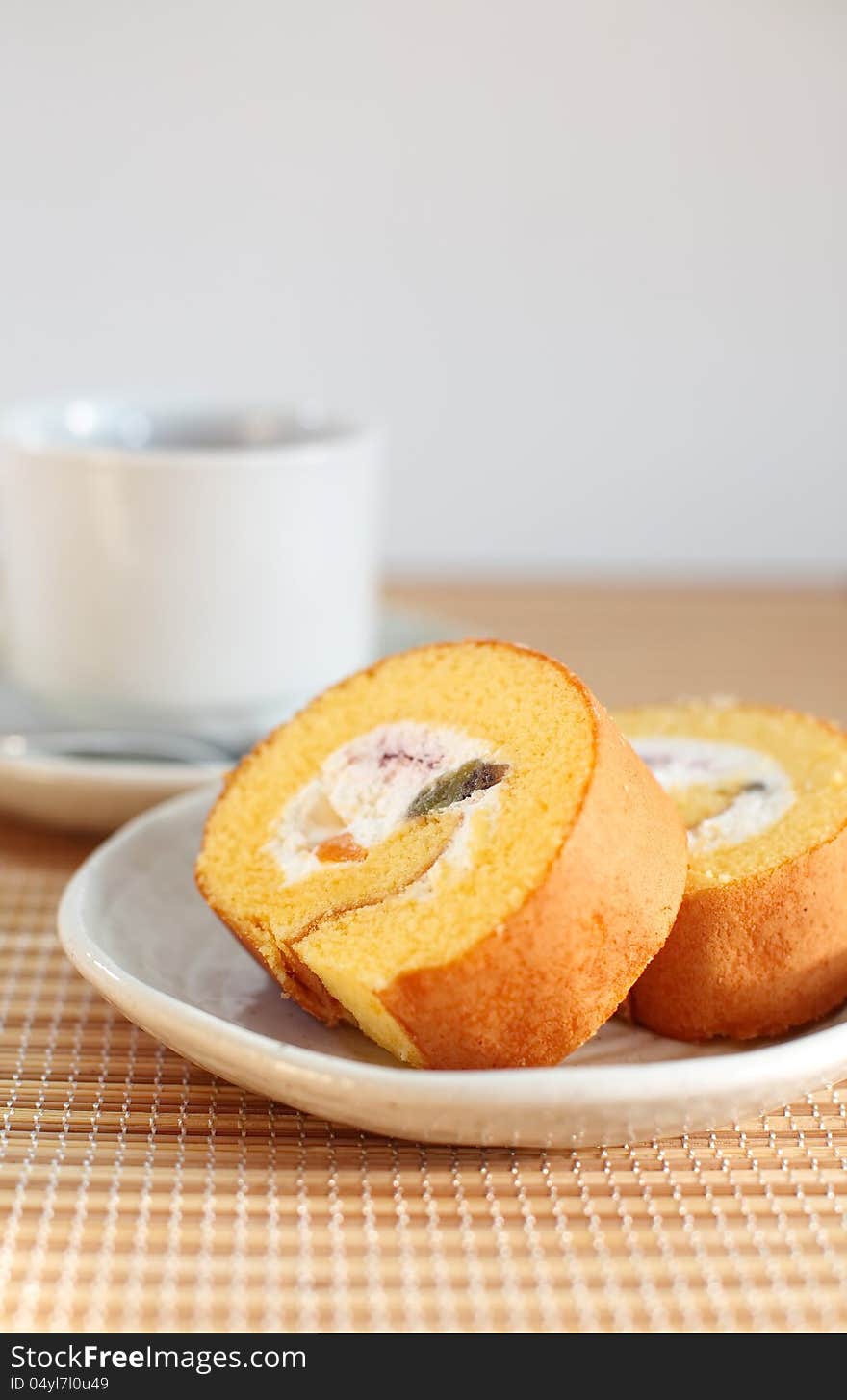 Roll cake with cup of tea