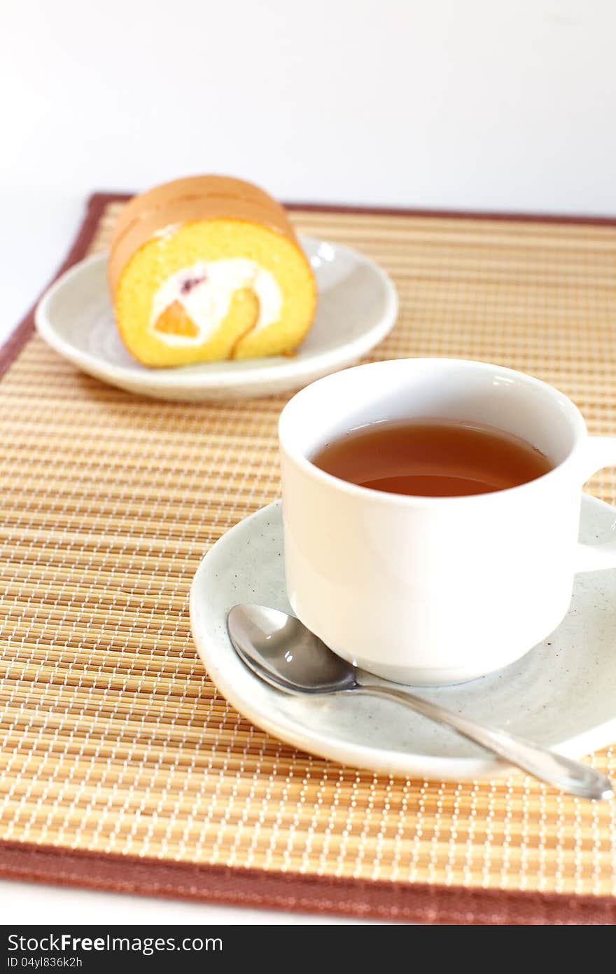 Roll cake with cup of tea