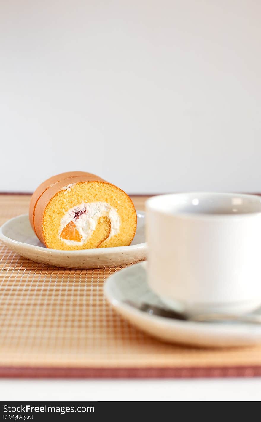 Roll cake with cup of tea