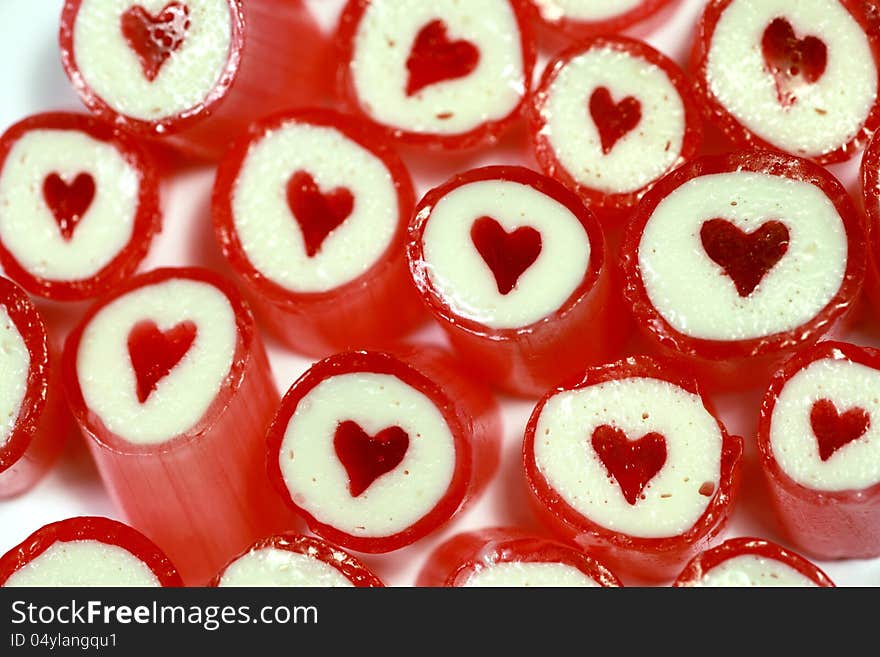 Close up of red and white candy pieces with red heart in the centre. Close up of red and white candy pieces with red heart in the centre.