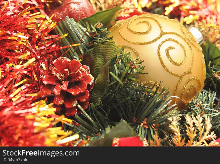 Gold christmas ball closeup with red decorations. Gold christmas ball closeup with red decorations