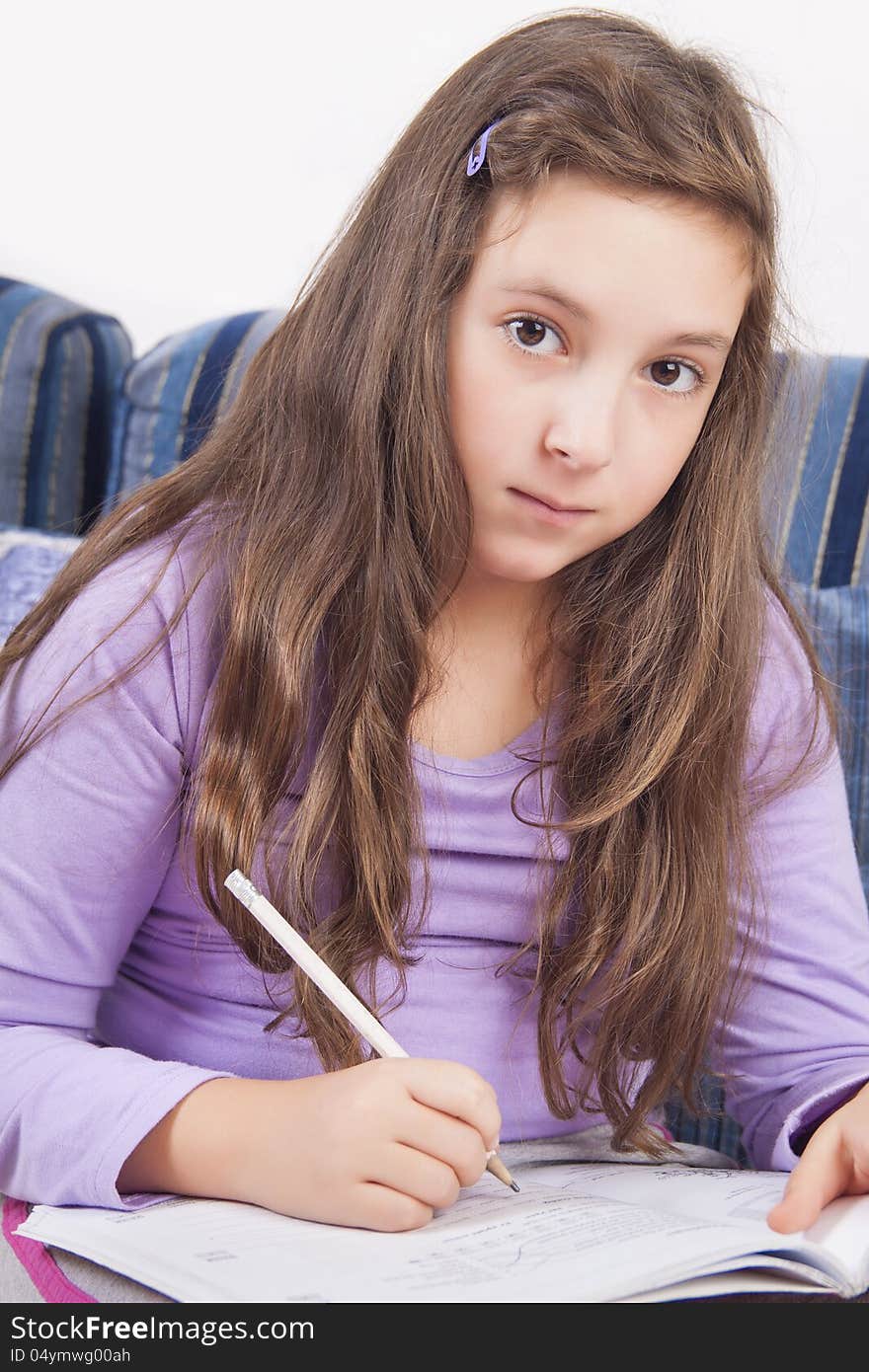 Girl writing homework at home. Girl writing homework at home