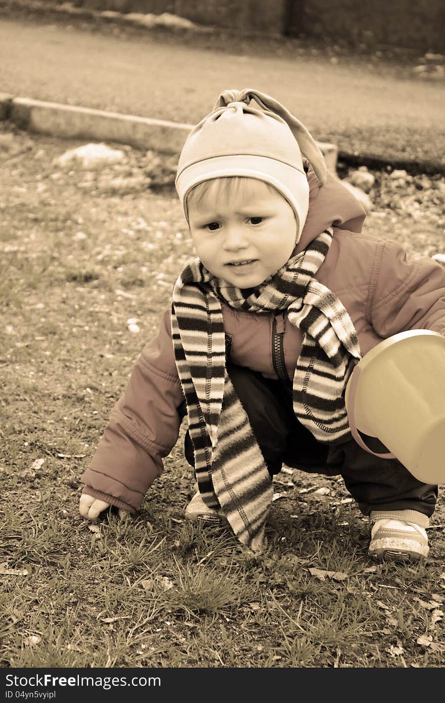 Portrait of the little lovely boy holding bucket