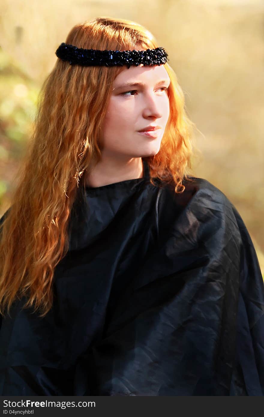 Portrait of the beautiful blonde girl in black dress