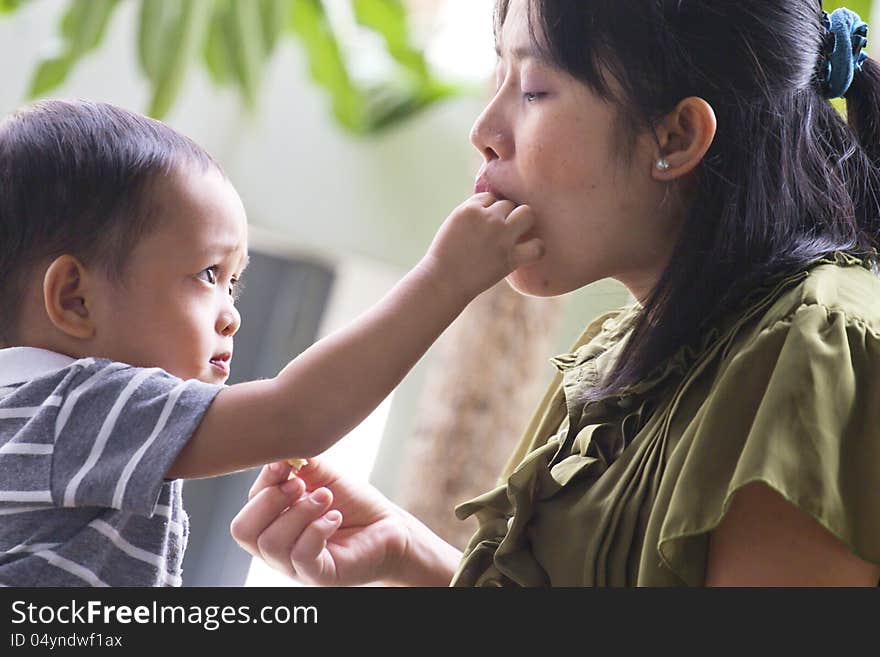 Little boy. Feeding pregnant mother. Little boy. Feeding pregnant mother