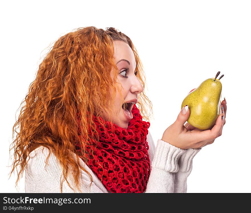 Surprised red-haired girl with a pears isolated on white