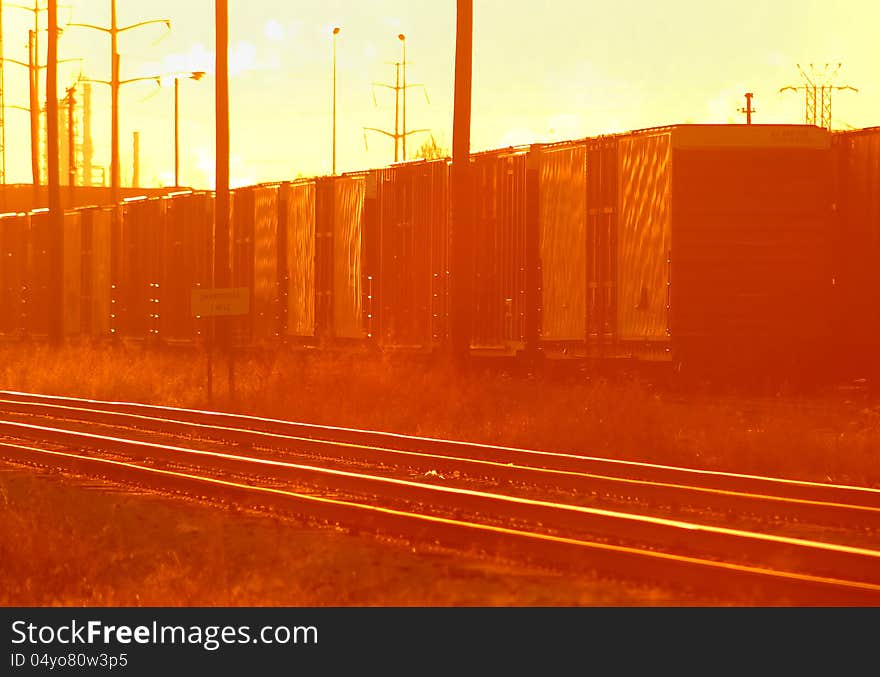 Train cars in yard at sunrise. Train cars in yard at sunrise