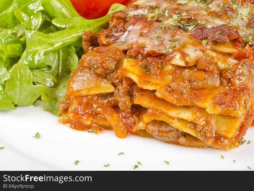 Closeup of a piece of meat lasagna and arugula salad #1. Closeup of a piece of meat lasagna and arugula salad #1.