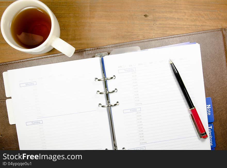 A cup of tea on notebook. A cup of tea on notebook