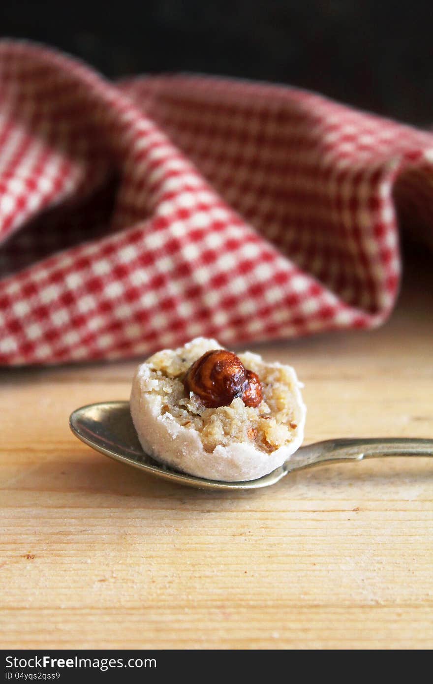 Cream and walnut sweets with hazelnuts on a spoon