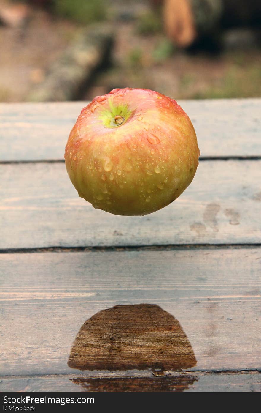 Ripe apple lying on a wooden table. Rural. Ripe apple lying on a wooden table. Rural.