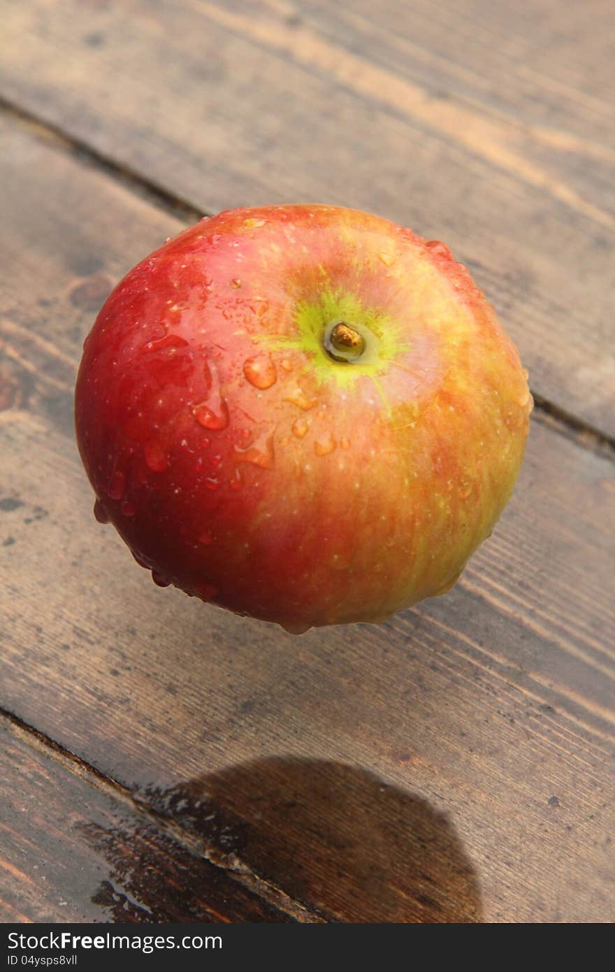 Ripe apple lying on a wooden table. Rural. Ripe apple lying on a wooden table. Rural.