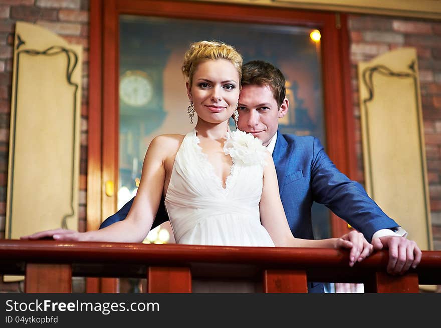 Happy bride and groom in interior