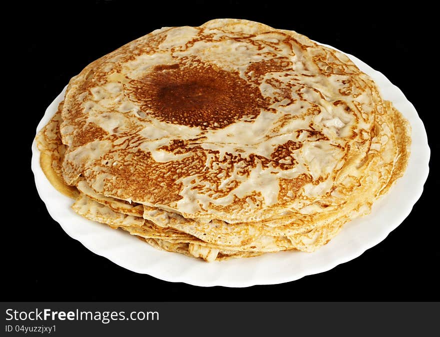 Fresh hot pancakes on white plate isolated on black background. Fresh hot pancakes on white plate isolated on black background