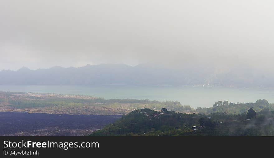 Foggy rural landscape with meadows a lake and mountains. Foggy rural landscape with meadows a lake and mountains