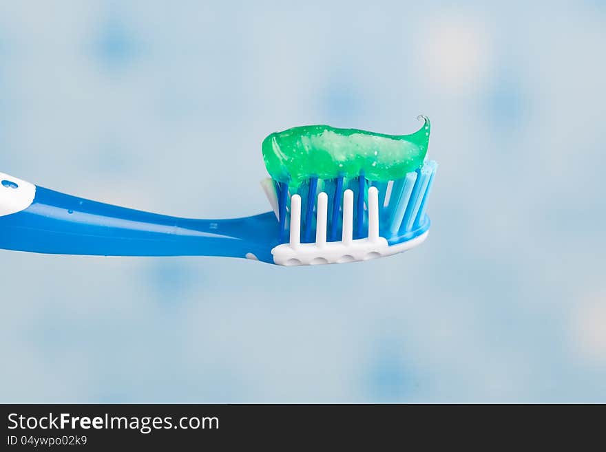 Toothbrush against blue tile background. Toothbrush against blue tile background