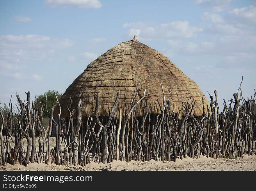 A photo of a bushmen hut in a native bsuhmen kraal in the Kalahari Desert where they live. Made of twigs and grass. A photo of a bushmen hut in a native bsuhmen kraal in the Kalahari Desert where they live. Made of twigs and grass.