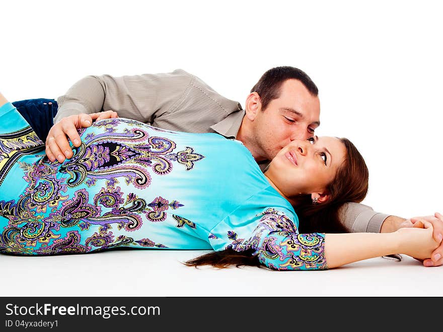 Husband lies next to the pregnant wife isolated on white background