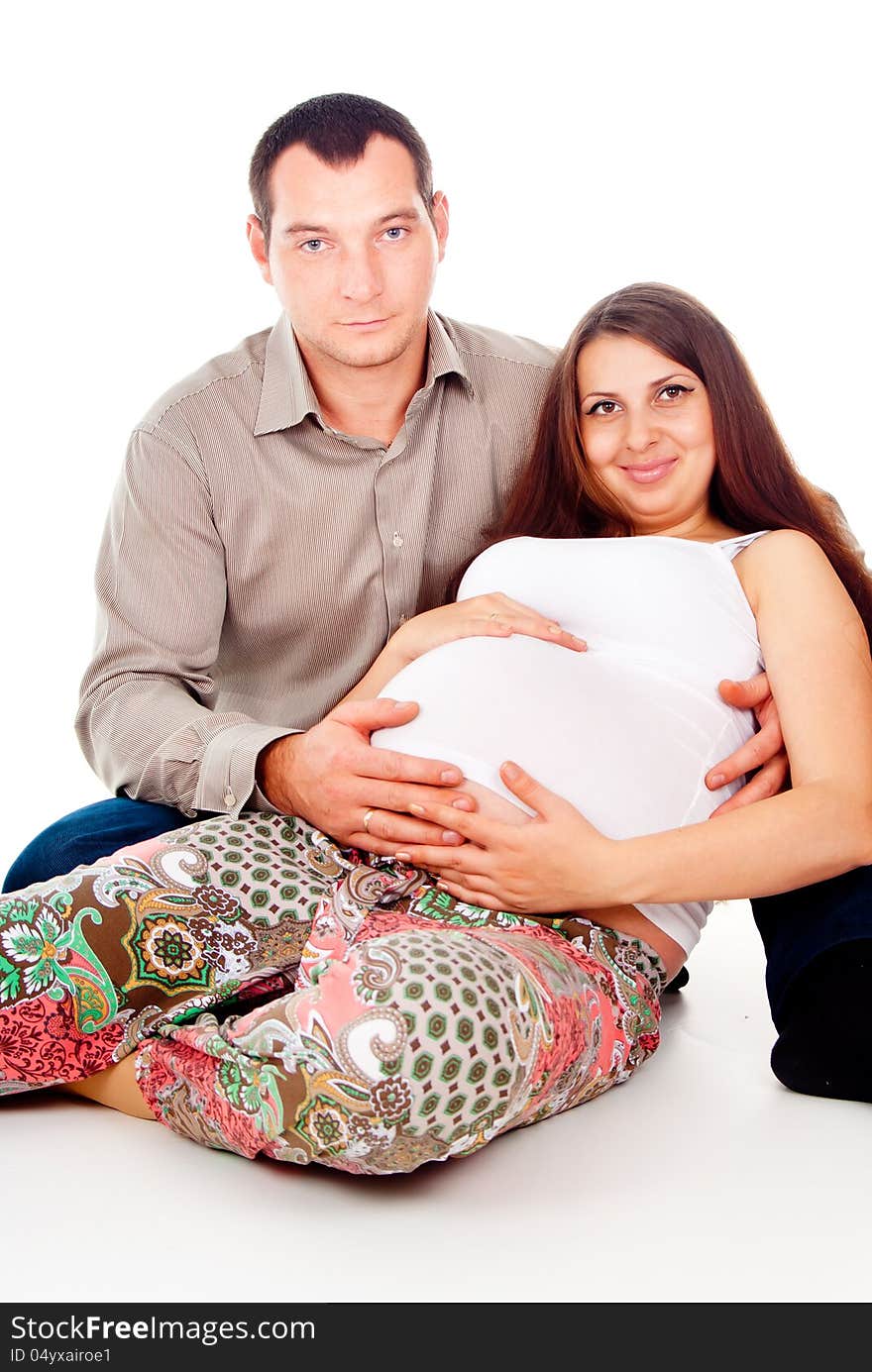 Husband hugs pregnant wife isolated on white background