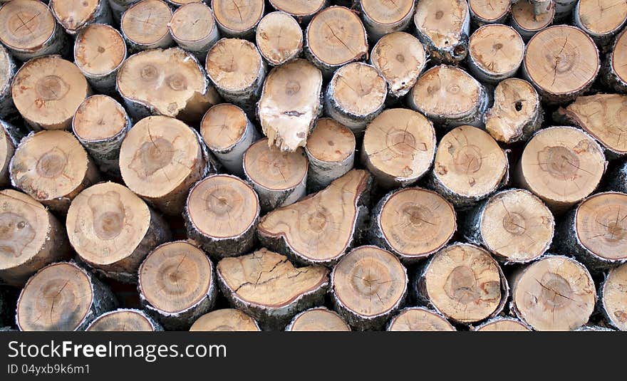 Background of Neatly Stacked Firewood closeup outdoors