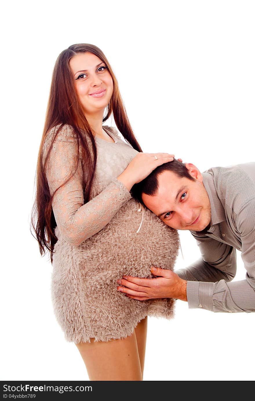 Dad listens to the belly of a pregnant wife isolated on white background