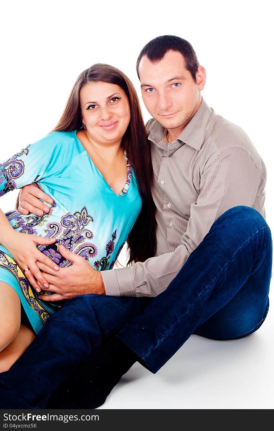 Dad hugs pregnant wife isolated on white background