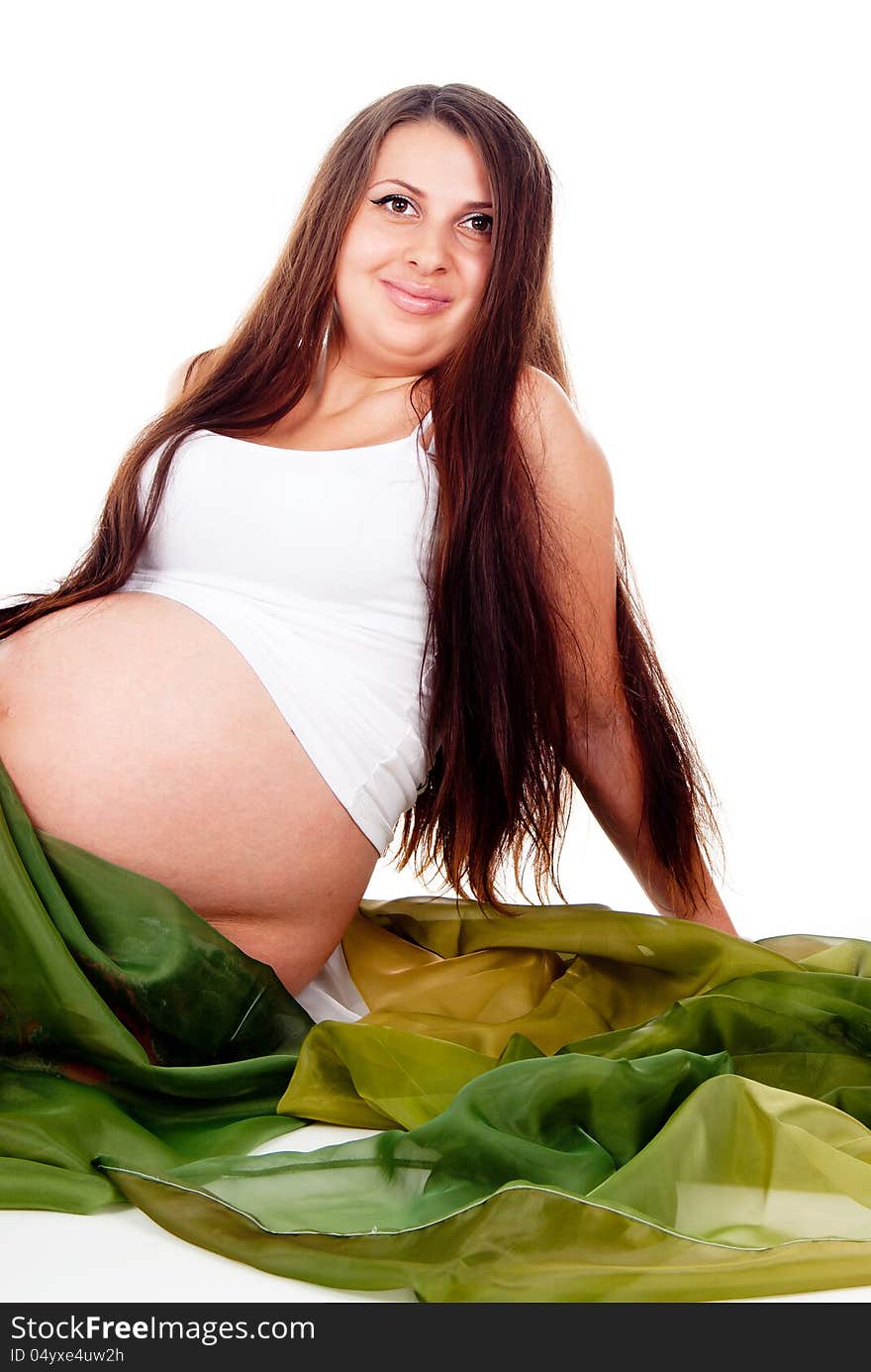 A pregnant girl in a green veil isolated on white background