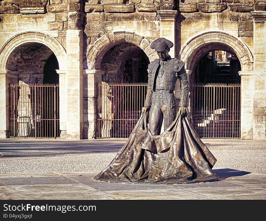 Roman Coliseum with a statue of a bullfighter- Nimes, France. Roman Coliseum with a statue of a bullfighter- Nimes, France