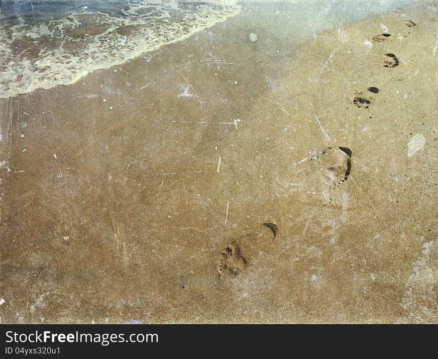 Vintage photo of footsteps in sand