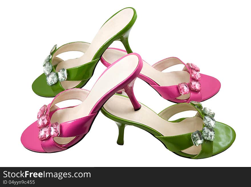 Two pairs pink and green shoes are photographed on a white background