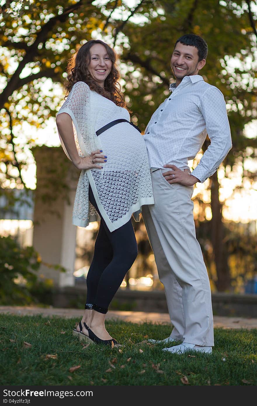 Pregnant couple resting in the park