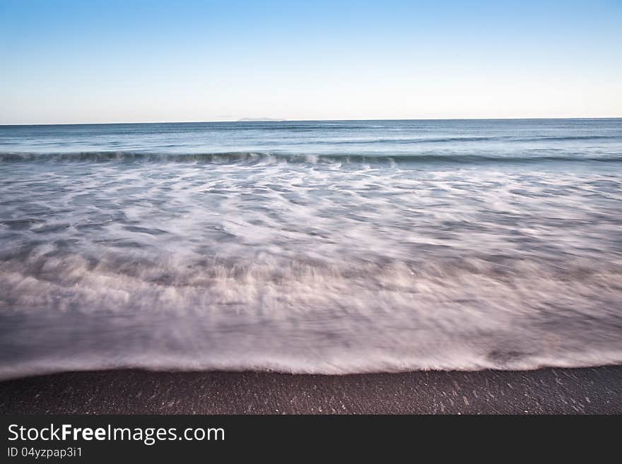 Smooth waves caught at slow shutter speed in morning light at Mount Maunganui. Smooth waves caught at slow shutter speed in morning light at Mount Maunganui.