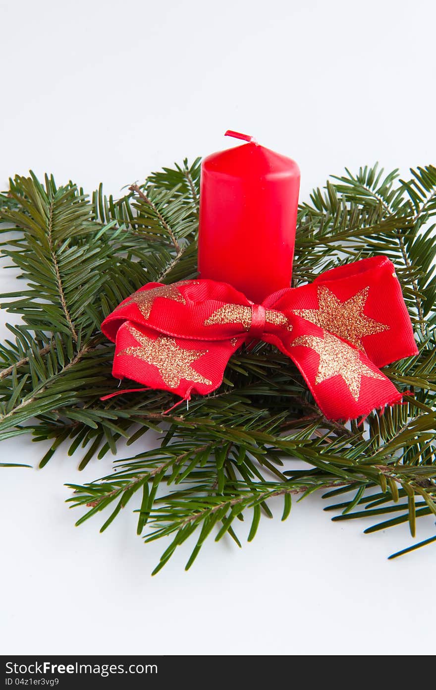 Red candle with a red bow on a white background