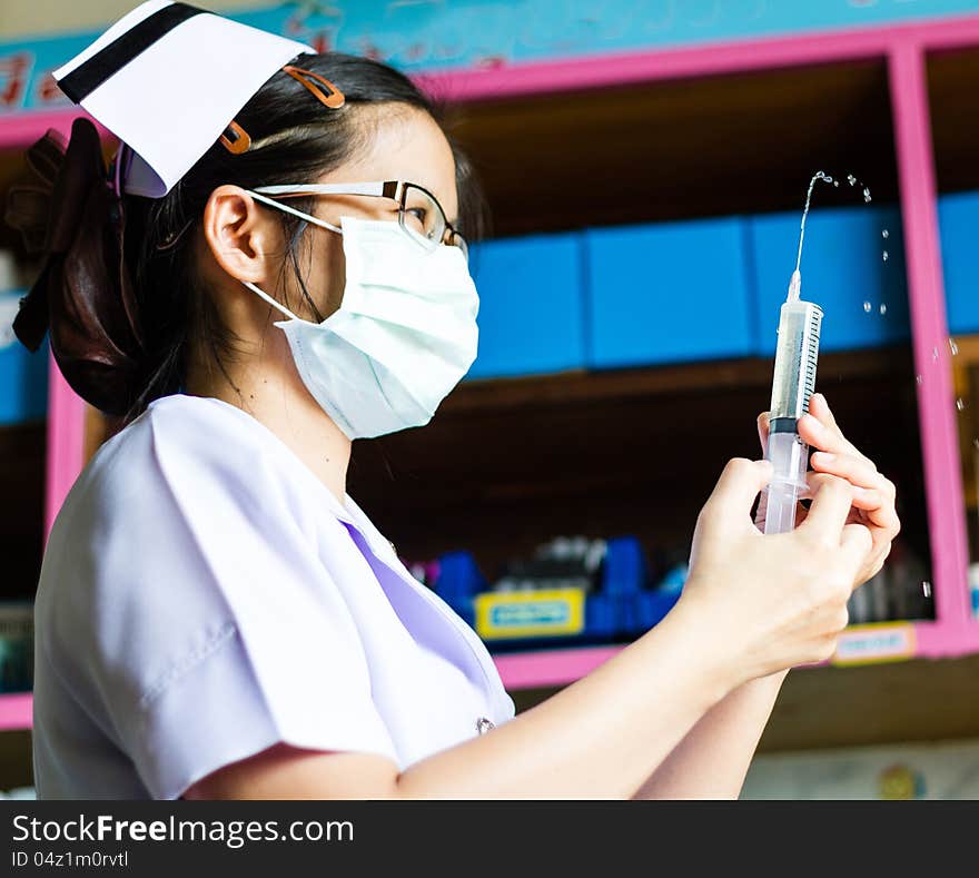 Nurse with medical syringe with needle in ampule getting ready for patient injection