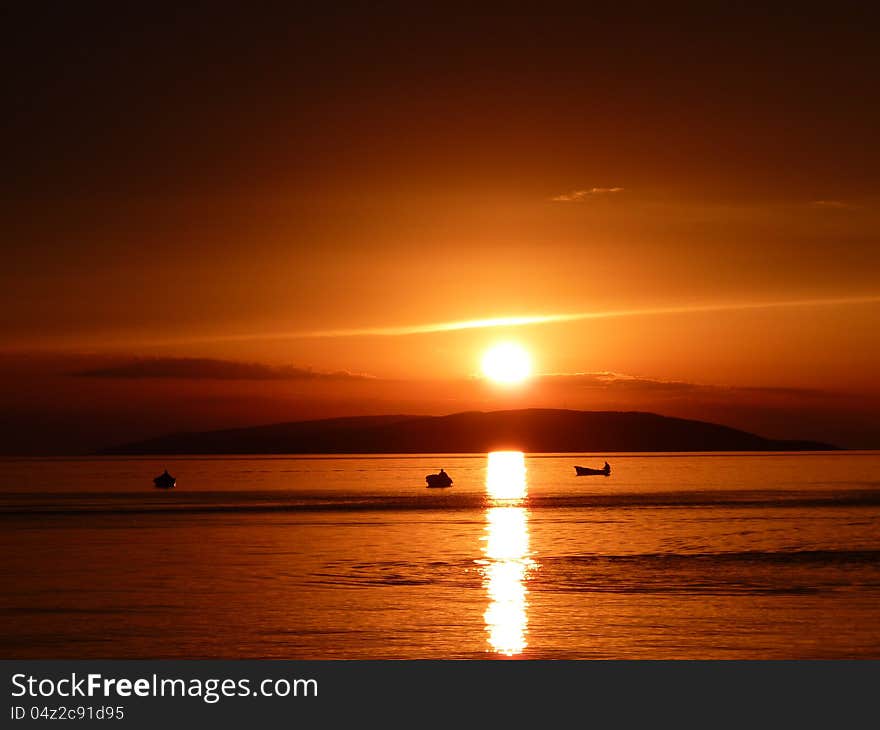 Sunset in Croatia with fishermen.