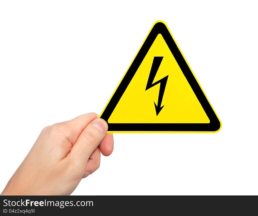 Isolated male hand holding yellow sign of danger high voltage symbol with lightning. Isolated male hand holding yellow sign of danger high voltage symbol with lightning