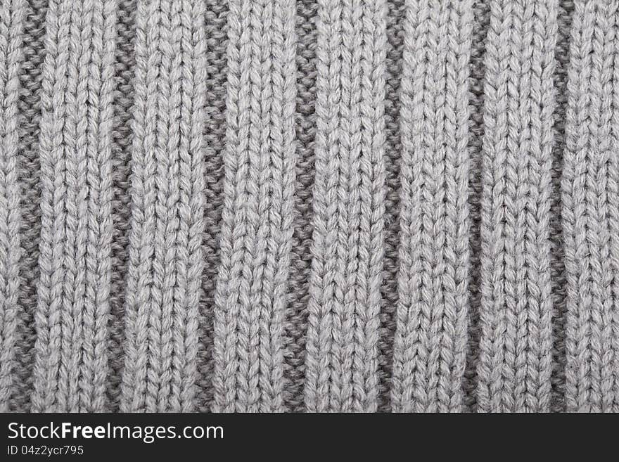 Gray knitted polosany material for use as a background. Gray knitted polosany material for use as a background