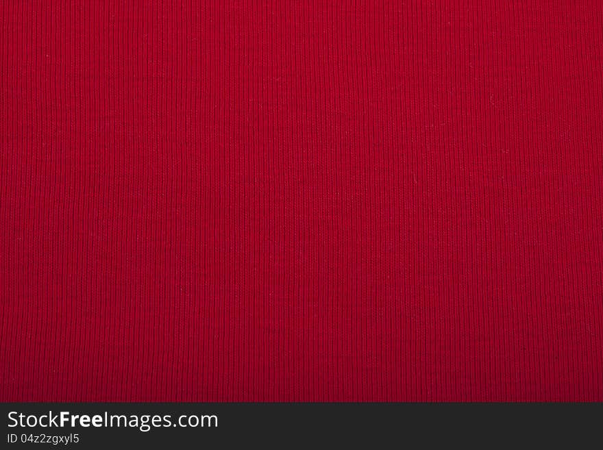 Red knitted material for use as a background. Red knitted material for use as a background