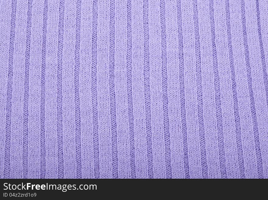 Purple knitted material for use as a background. Purple knitted material for use as a background