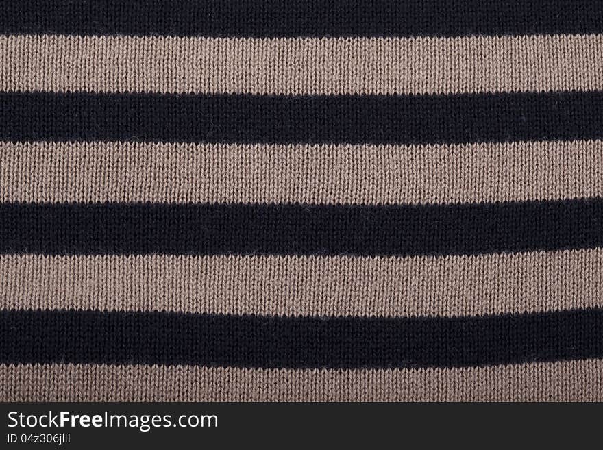 Knitted background with black and brown stripes