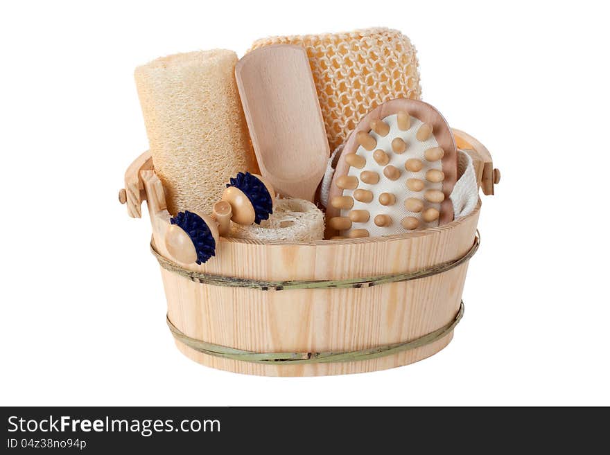 Massage and sauna supplies in a wooden bucket - isolated. Massage and sauna supplies in a wooden bucket - isolated