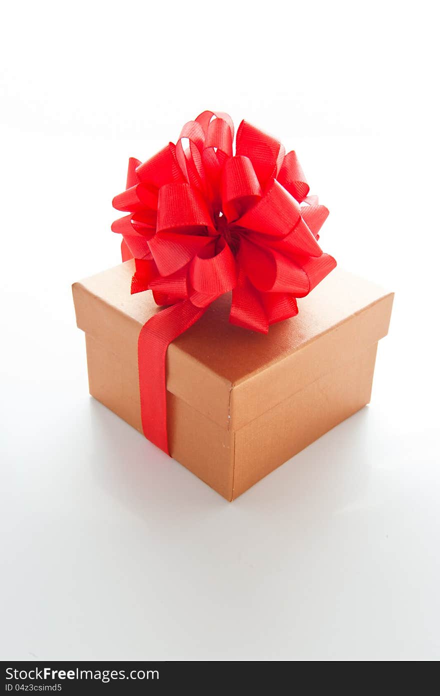 Brown gift box for Christmas with a red bow