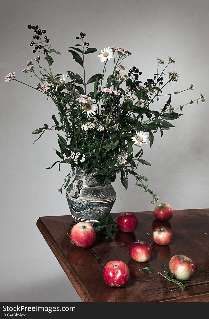 Autumn still life with apple and flowers